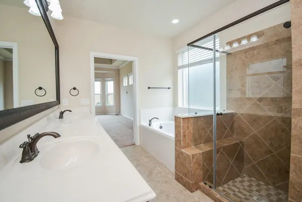 a bathroom with a tub sink and mirror
