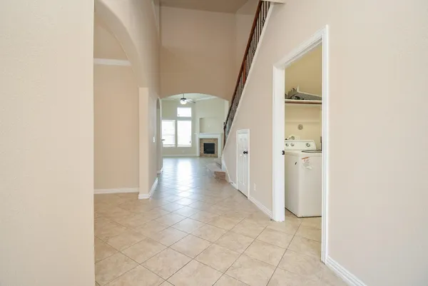 a view of a hallway with a white walls and stairs