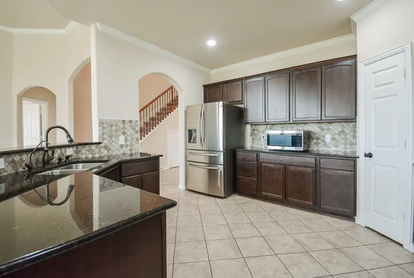 a kitchen with a sink microwave and refrigerator