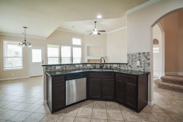 a kitchen with a sink counter top space cabinets and stainless steel appliances