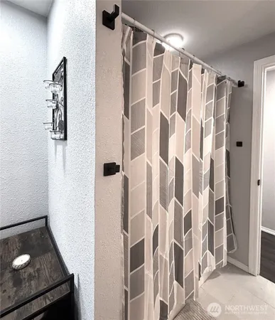 a bathroom with a shower curtain and a sink