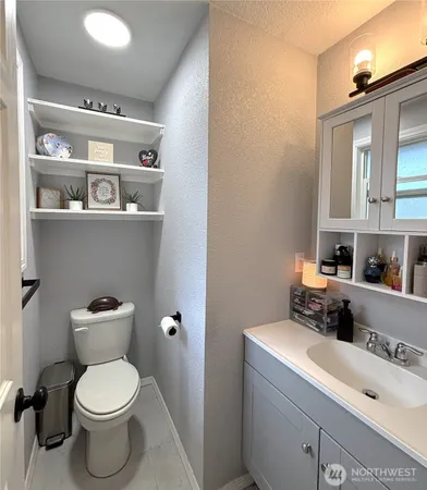 a bathroom with a toilet a sink and a mirror