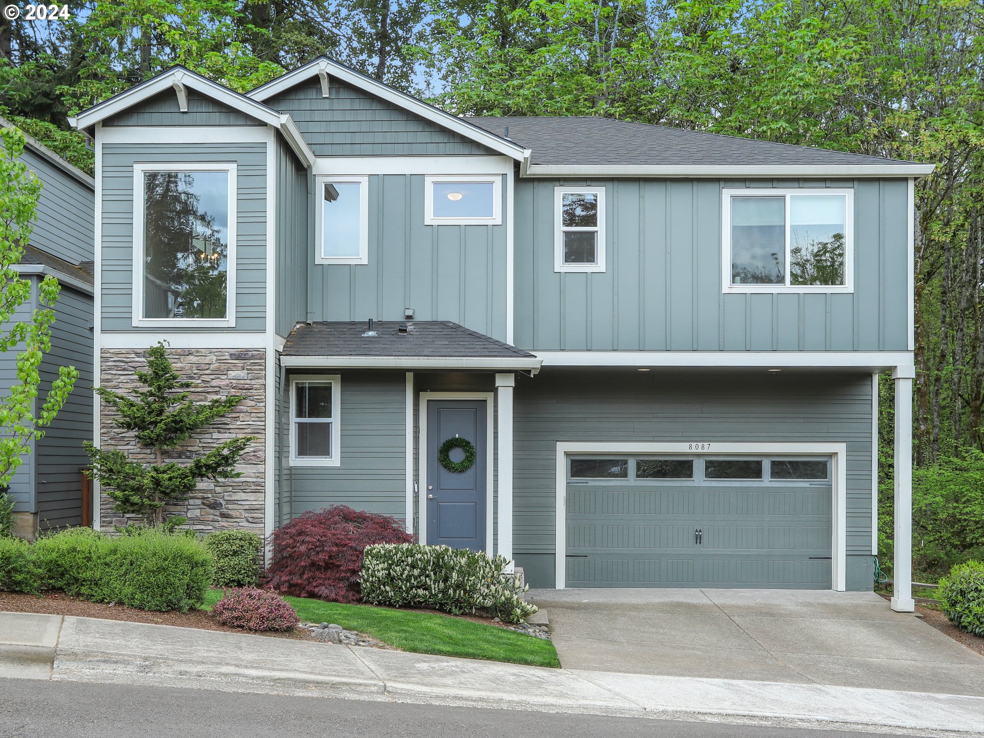 a front view of a house with a garden