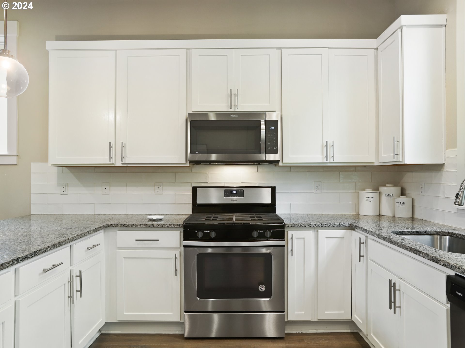 8087 Southwest Oldham Drive Beaverton, OR 97007 - Photo 15 of 46 a kitchen with granite countertop white cabinets and stainless steel appliances