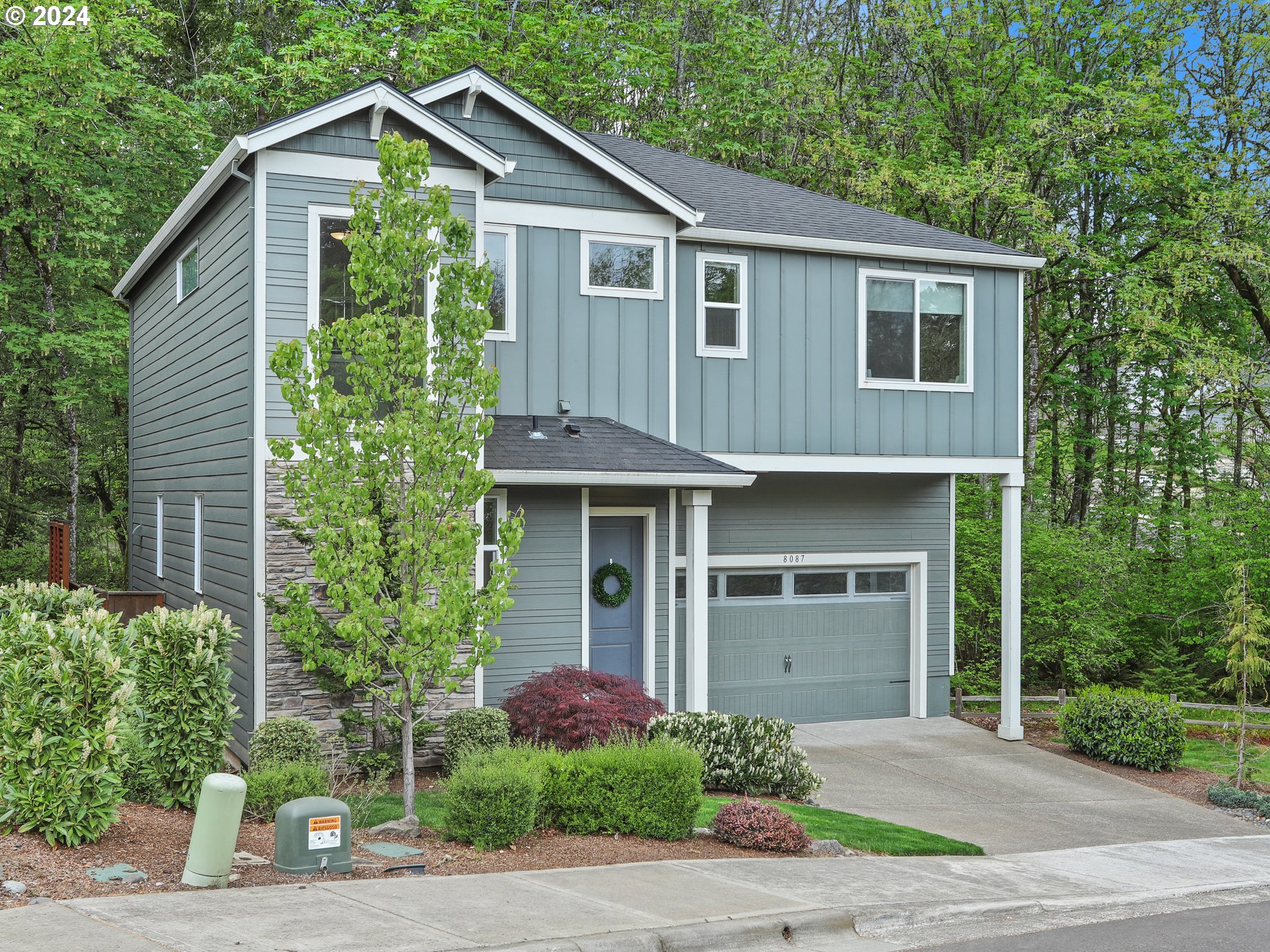 8087 Southwest Oldham Drive Beaverton, OR 97007 - Photo 2 of 46 a front view of a house with a yard and trees