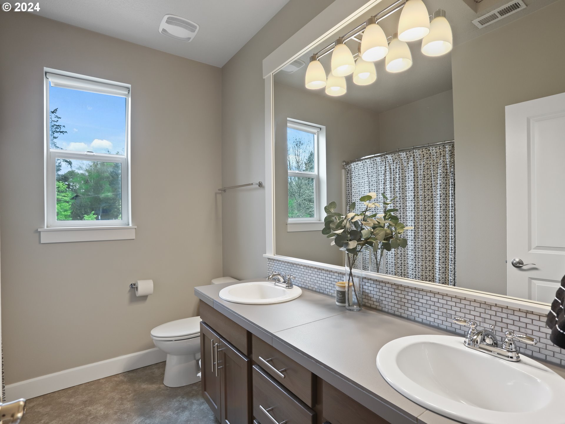 8087 Southwest Oldham Drive Beaverton, OR 97007 - Photo 36 of 46 a bathroom with a sink a toilet and a mirror