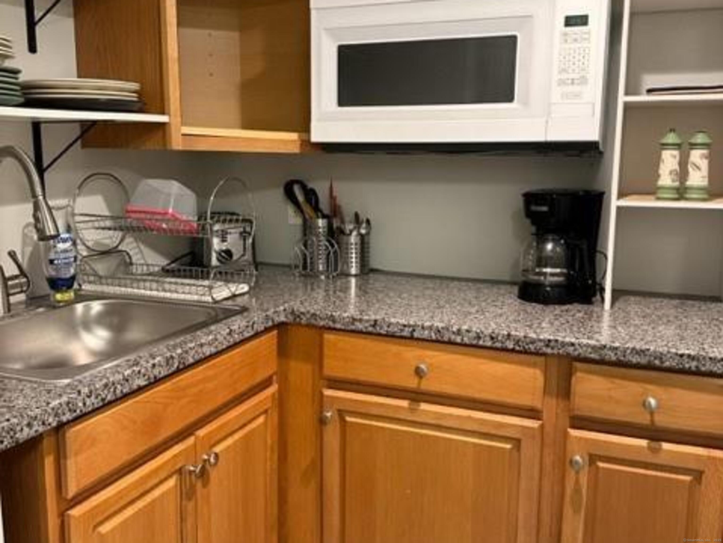 94 William Street New Haven, CT 06511 - Photo 3 of 8 a kitchen with granite countertop a sink a stove and cabinets