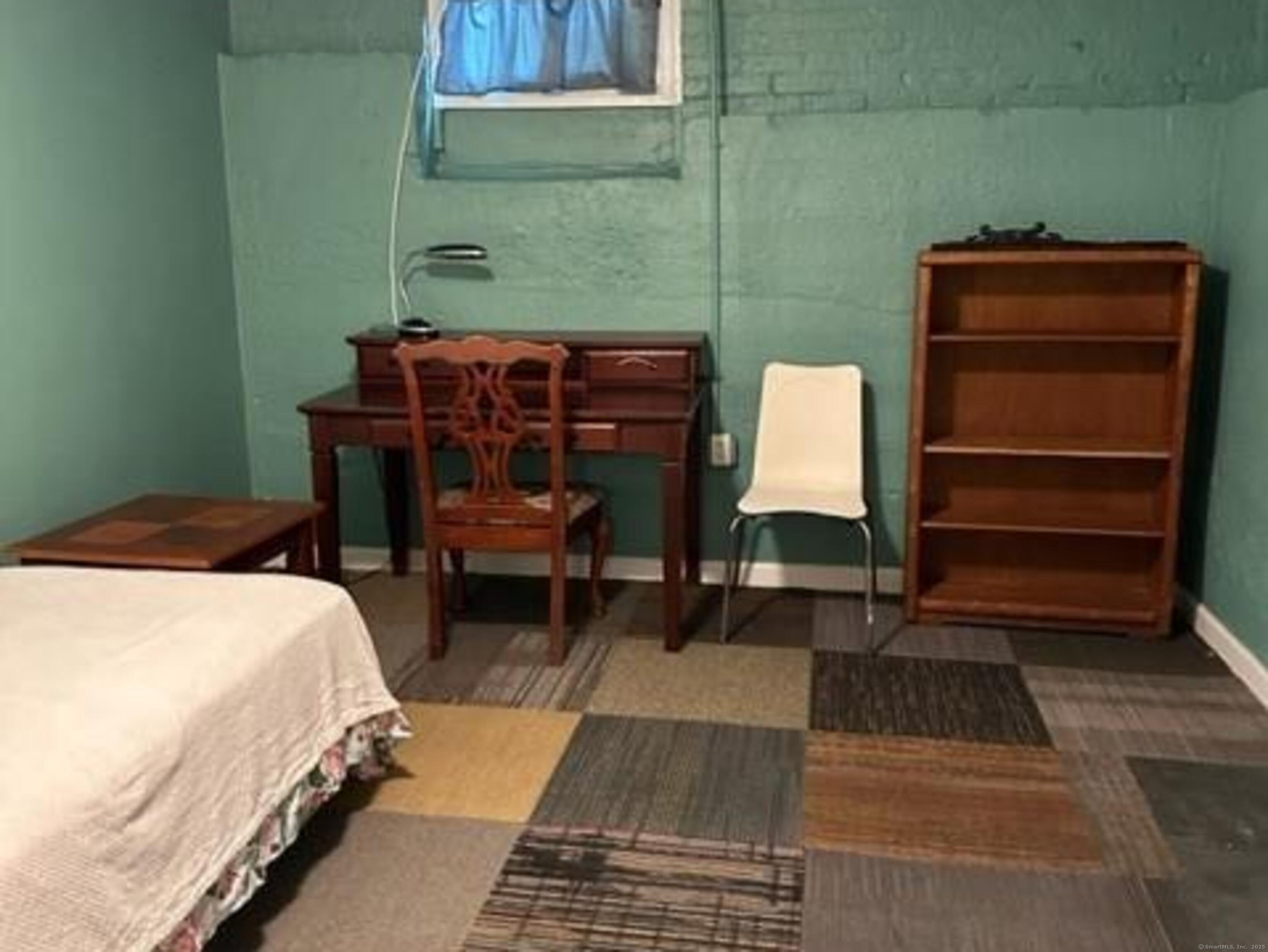 94 William Street New Haven, CT 06511 - Photo 5 of 8 a bedroom with a bed and a bookshelf with wooden floor