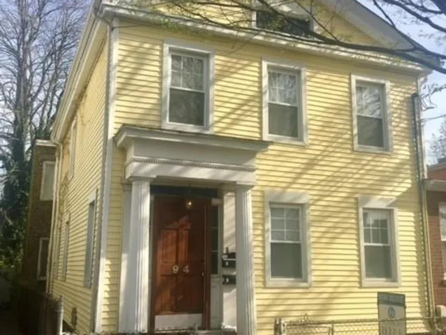 a view of a brick house with a large windows