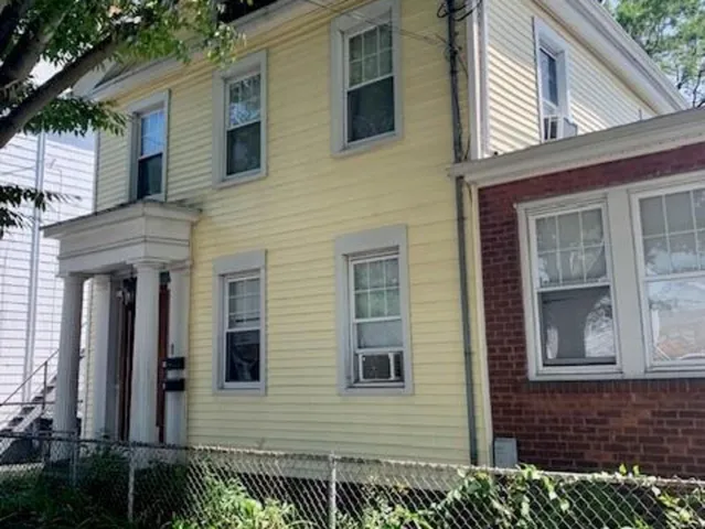 a view of a brick house with many windows