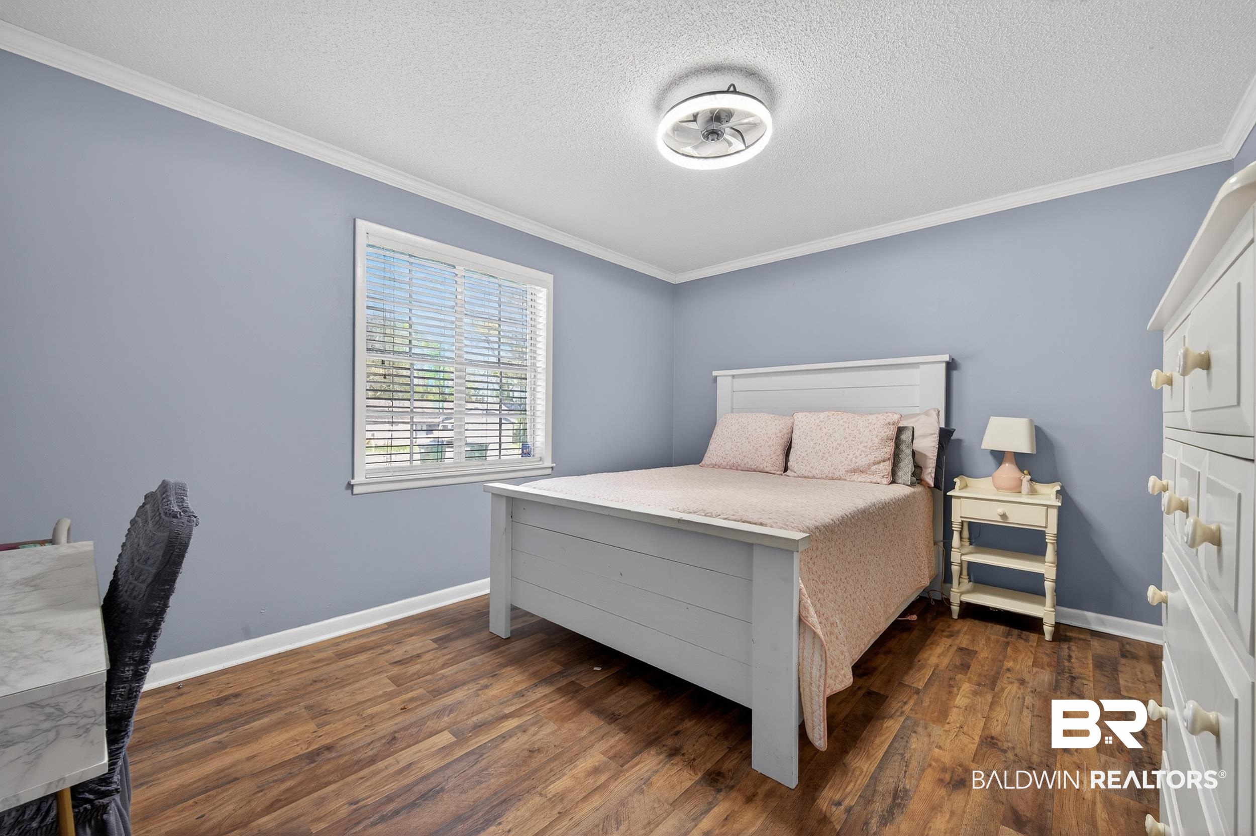 46006 Pecan Lane Bay Minette, AL 36507 - Photo 24 of 40 Bedroom featuring ornamental molding, dark wood-style flooring, and a textured ceiling