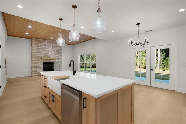 a kitchen with white cabinets and appliances
