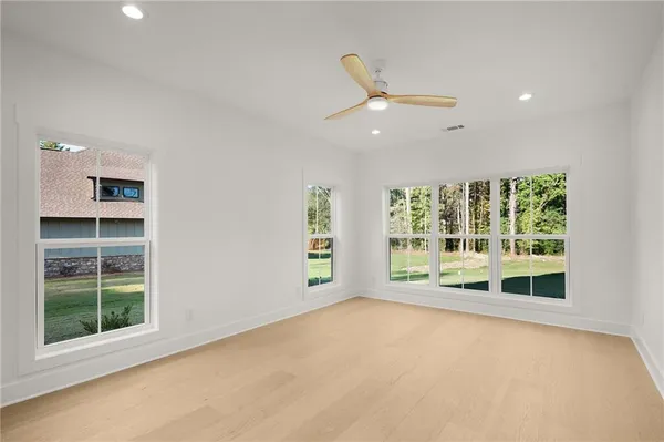an empty room with windows and closet