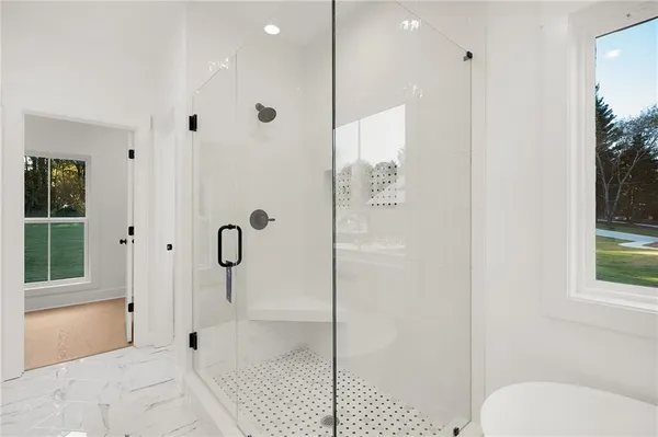 a bathroom with a bathtub and a window