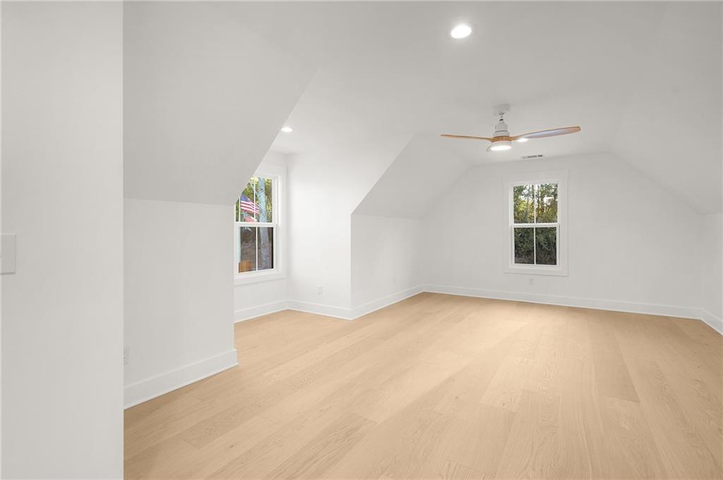 140 Cambridge Court Calhoun, GA 30701 - Photo 24 of 29 an empty room with a ceiling fan and windows