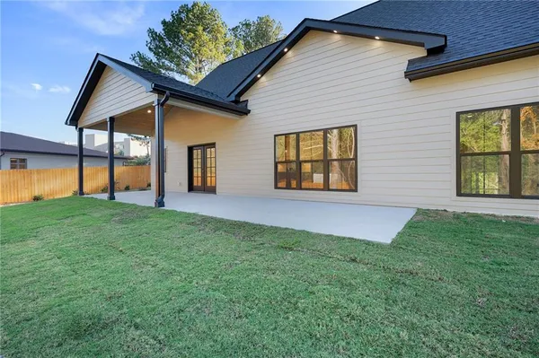 a front view of a house with a garden and yard