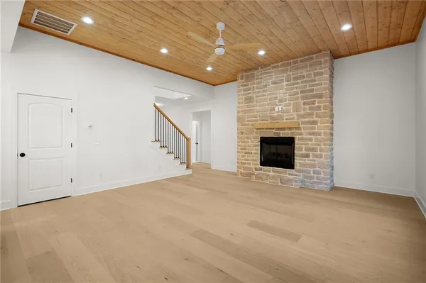 a view of kitchen with refrigerator and white cabinets