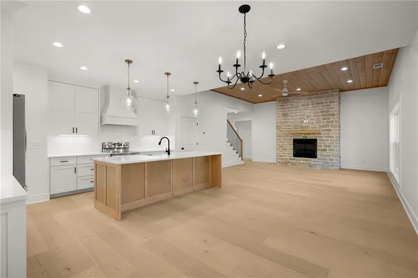 en empty room with windows and chandelier