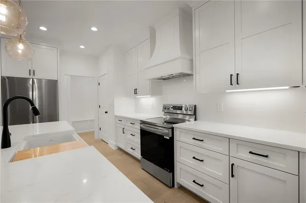 a kitchen with a refrigerator and cabinets
