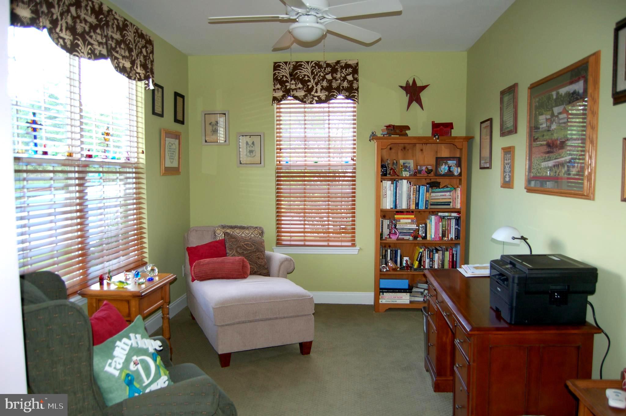 Office with lighted ceiling fan
