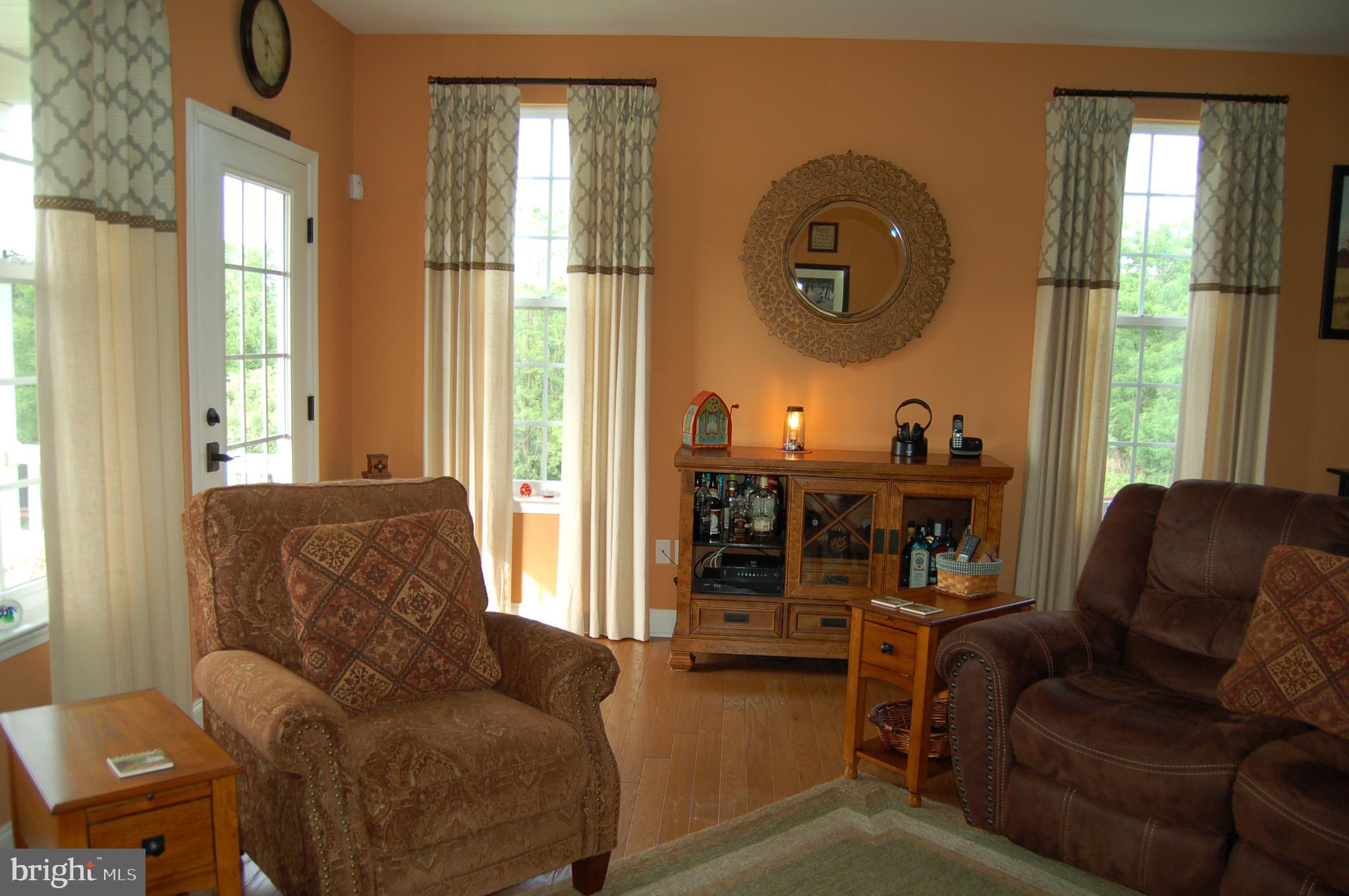 Living room portion of great room; custom drapes