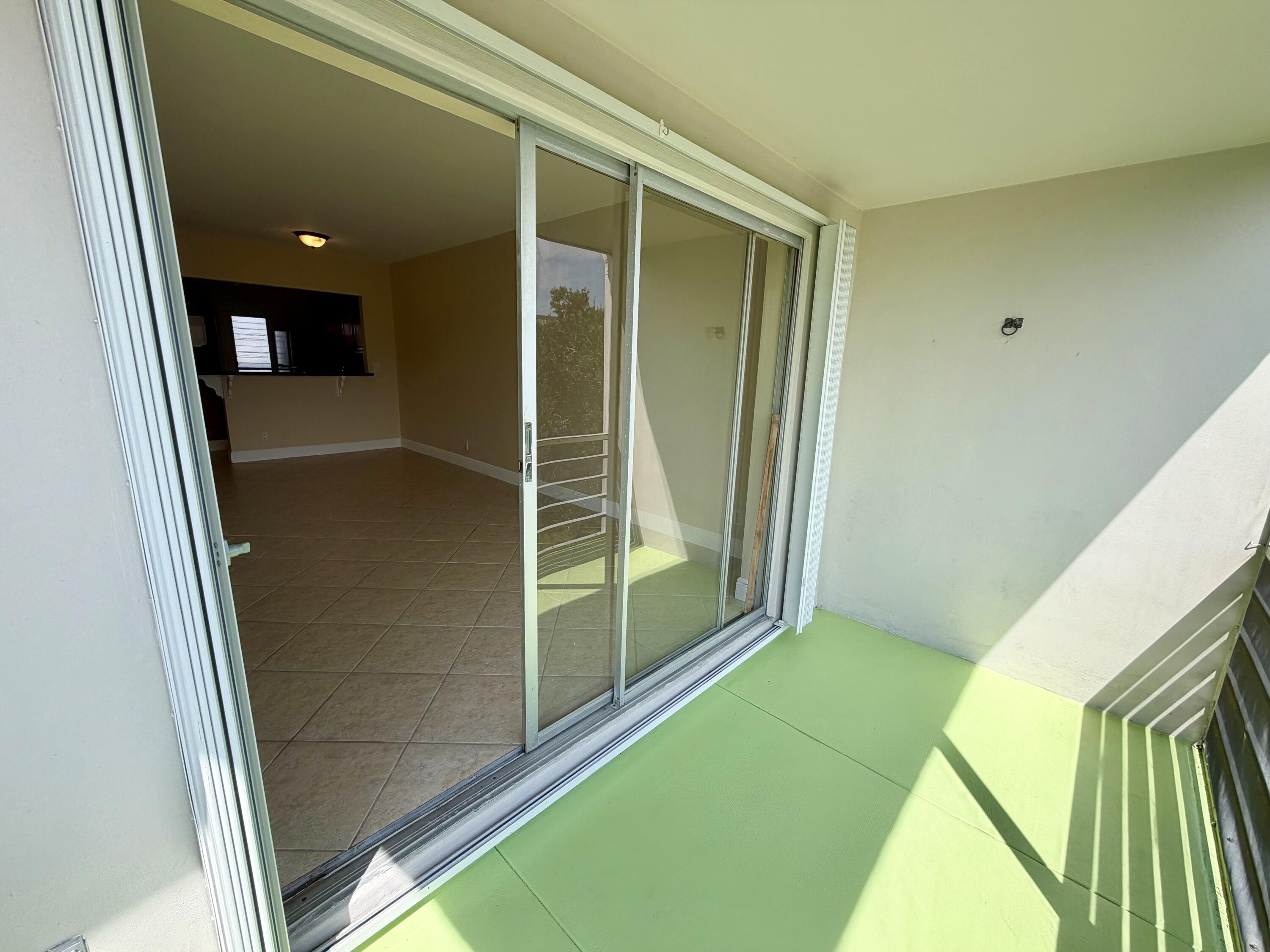 5601 Northwest 2nd Avenue, Unit 326 Boca Raton, FL 33487 - Photo 10 of 12 Patio sliders and hurricane shutters