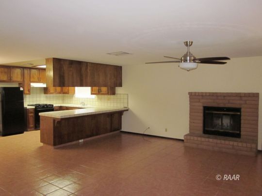 330 East Wilson Avenue Ridgecrest, CA 93555 - Photo 11 of 29 a kitchen with granite countertop a stove cabinets and a refrigerator