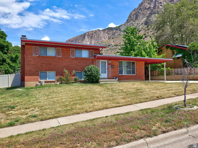 1272 Cook Street Ogden, UT 84404 - Photo 49 of 58 Brick exterior residence featuring a flat roofline and a covered entry