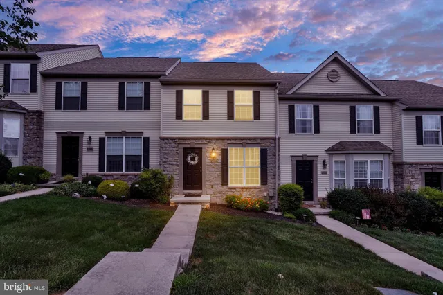a front view of a house with a yard and porch
