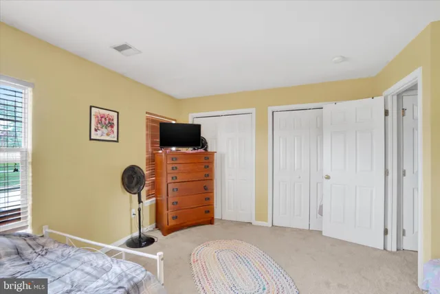 a bedroom with a bed and a cabinets