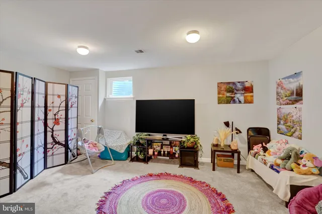 a bedroom with bed and a flat screen tv