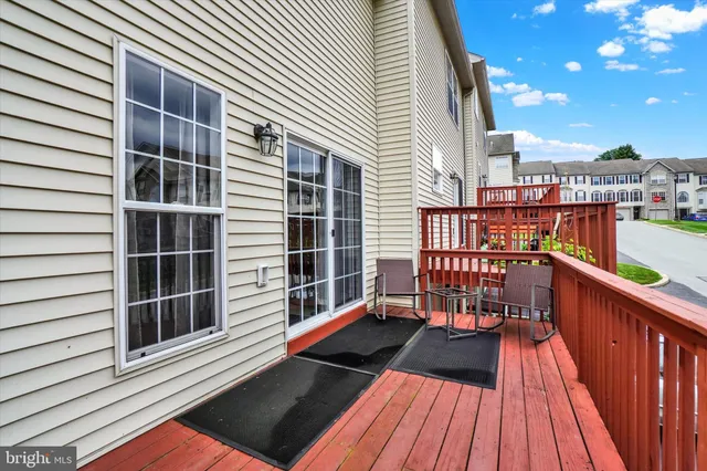a view of balcony with wooden floor and seating space