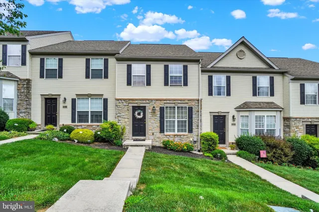 a front view of a house with a yard and porch