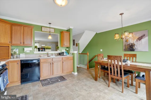 a kitchen with a sink cabinets and wooden floor
