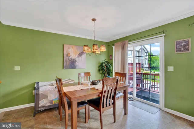 a dining room with furniture a rug and a chandelier