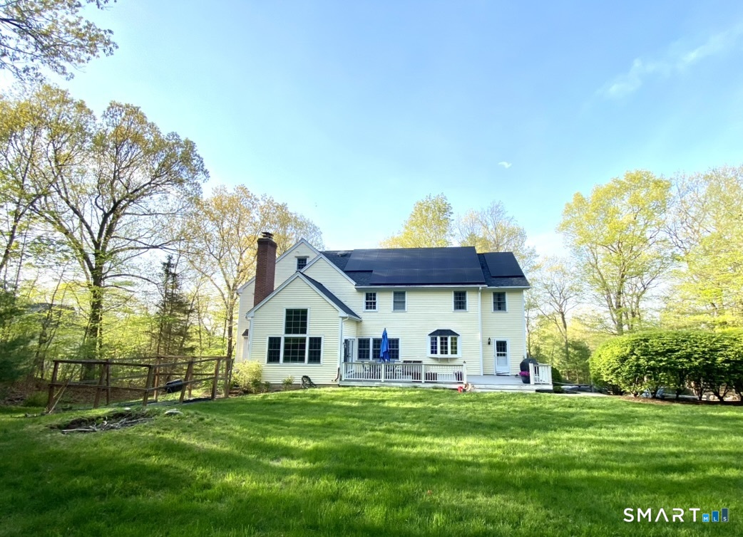 12 Carriage Hill Road Woodbridge, CT 06525 - Photo 3 of 24 a front view of a house with a garden
