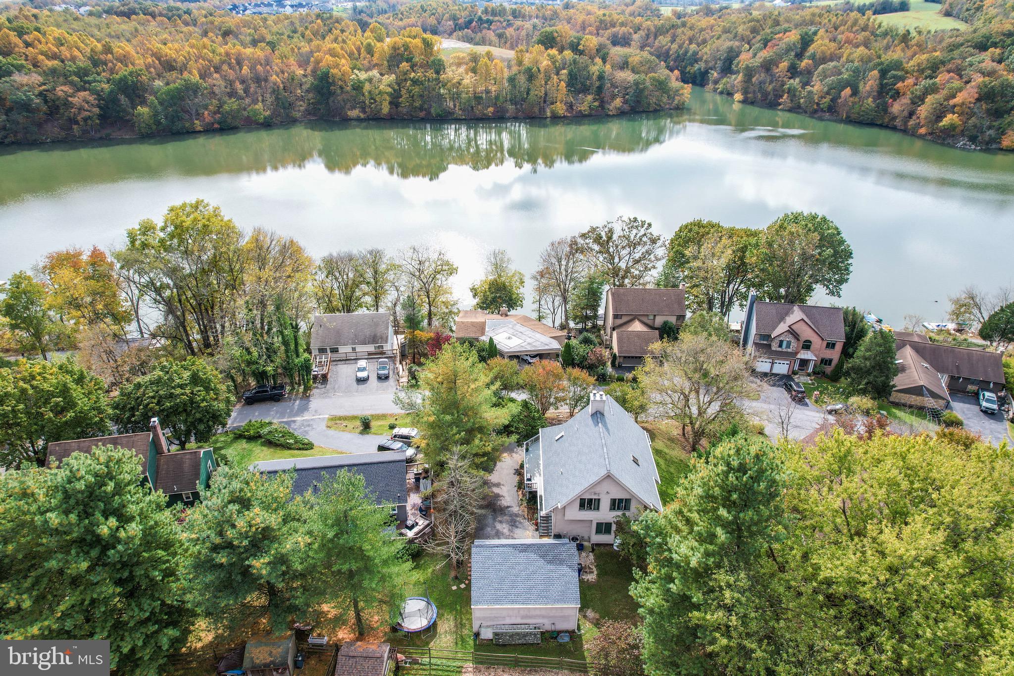 an aerial view of a house with garden space and lake view