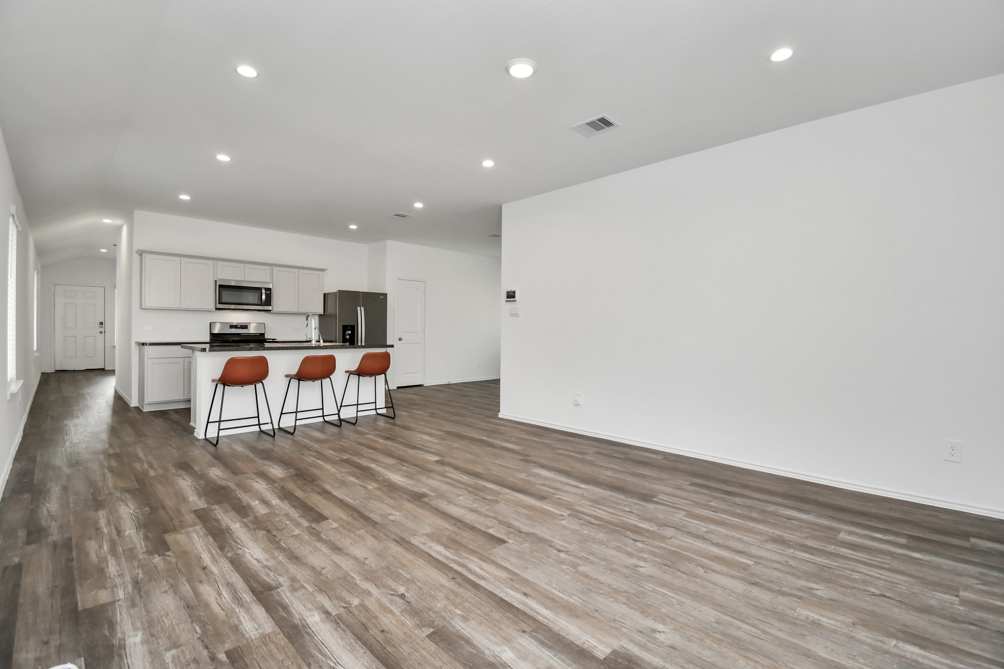 5315 Castlebury Meadows Dr Spring Spring, TX 77373 - Photo 13 of 39 a living room with stainless steel appliances kitchen island furniture and wooden floor