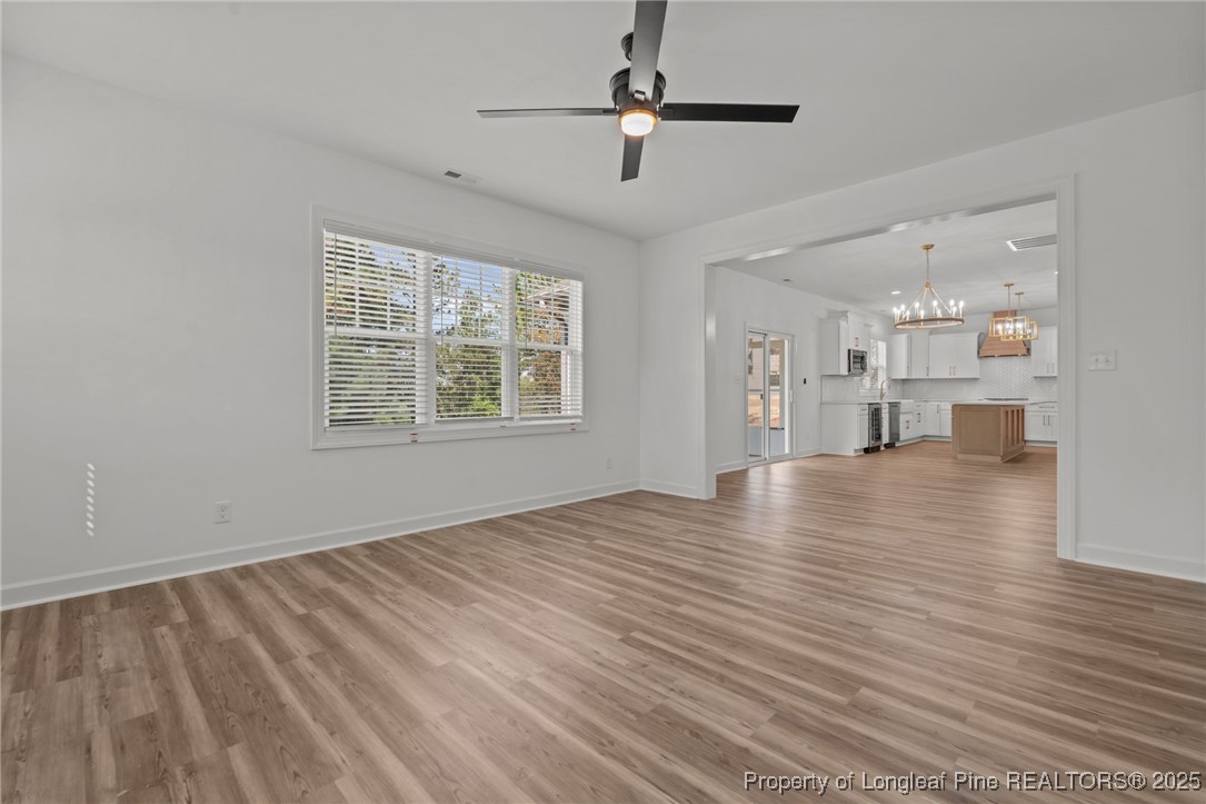 58 Magnolia Grv Way Cameron, NC 28326 - Photo 11 of 25 a view of an empty room with window and wooden floor