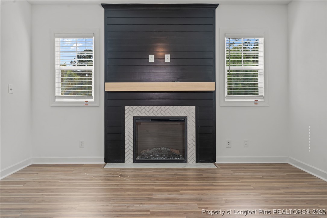 58 Magnolia Grv Way Cameron, NC 28326 - Photo 13 of 25 a view of an empty room with wooden floor and a fireplace