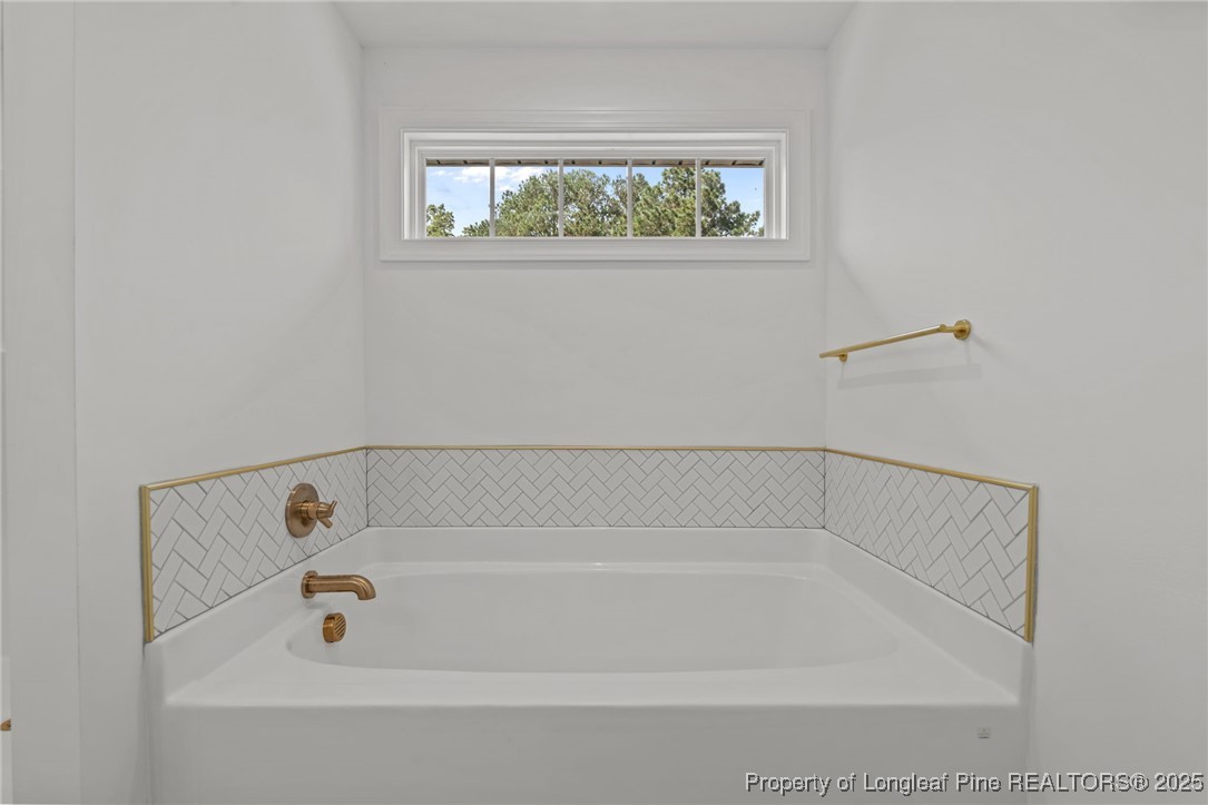 58 Magnolia Grv Way Cameron, NC 28326 - Photo 22 of 25 a bathroom with a bath tub and a window