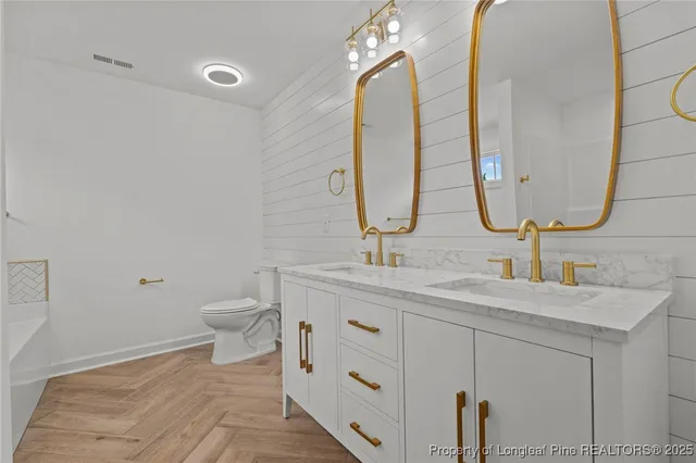 a bathroom with a double vanity sink and a mirror