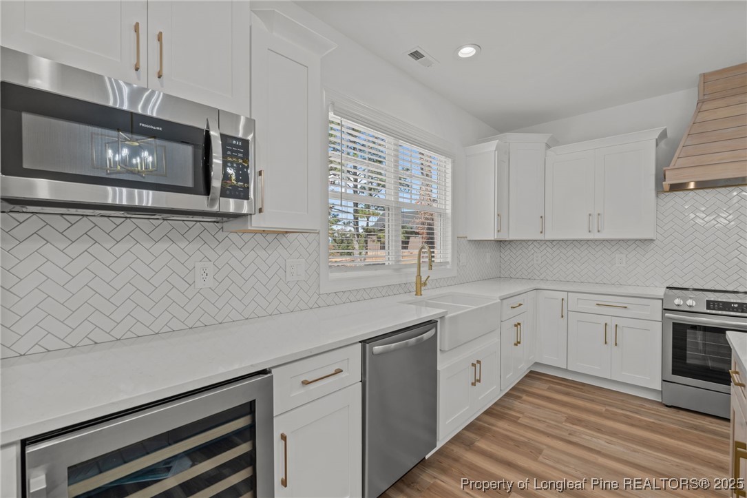 58 Magnolia Grv Way Cameron, NC 28326 - Photo 5 of 25 a kitchen with stainless steel appliances white cabinets and a window