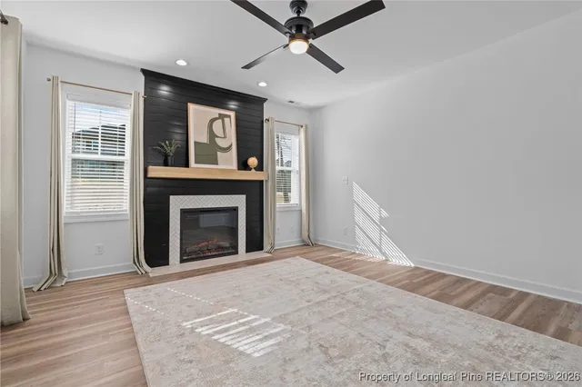 a living room with a couch and a dining table with wooden floor