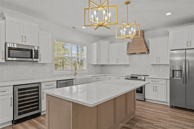 a kitchen with a sink a stove a microwave and refrigerator