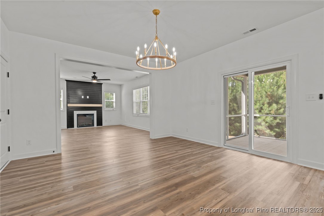 58 Magnolia Grv Way Cameron, NC 28326 - Photo 9 of 25 a view of an empty room with a window and wooden floor