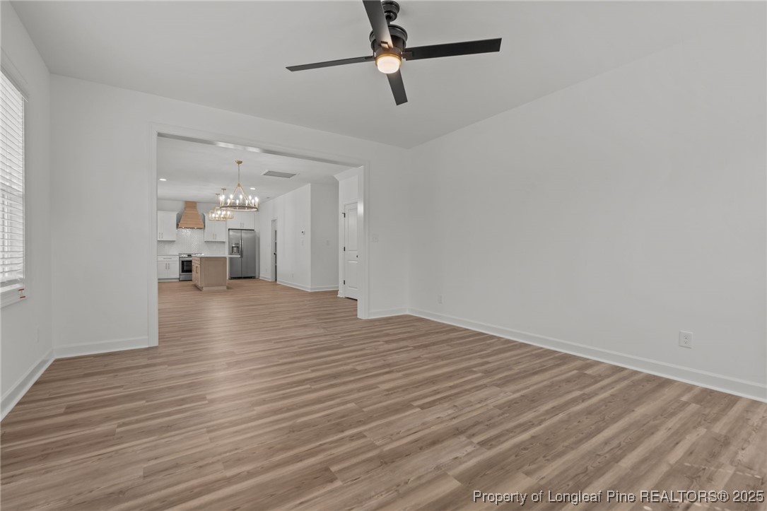 58 Magnolia Grv Way Cameron, NC 28326 - Photo 10 of 25 a view of a livingroom with wooden floor and a ceiling fan