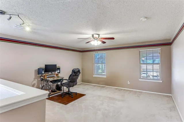 a spacious bedroom with a bed and a large window