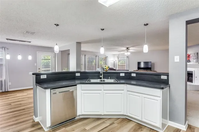a kitchen with stainless steel appliances granite countertop a sink a stove and a refrigerator