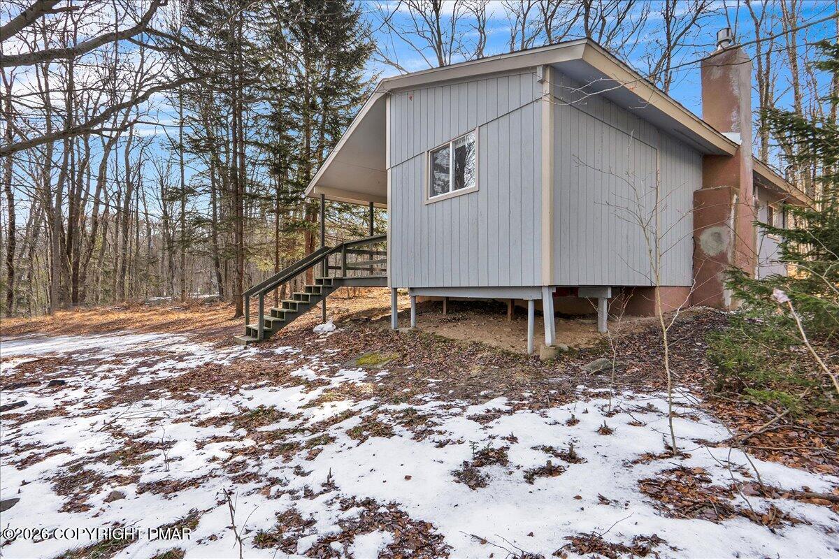 309 Selig Road Pocono Lake, PA 18347 - Photo 21 of 25 a backyard of a house with a yard and swing